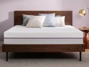 the purple mattress on a wooden frame in a minimalistic bedroom