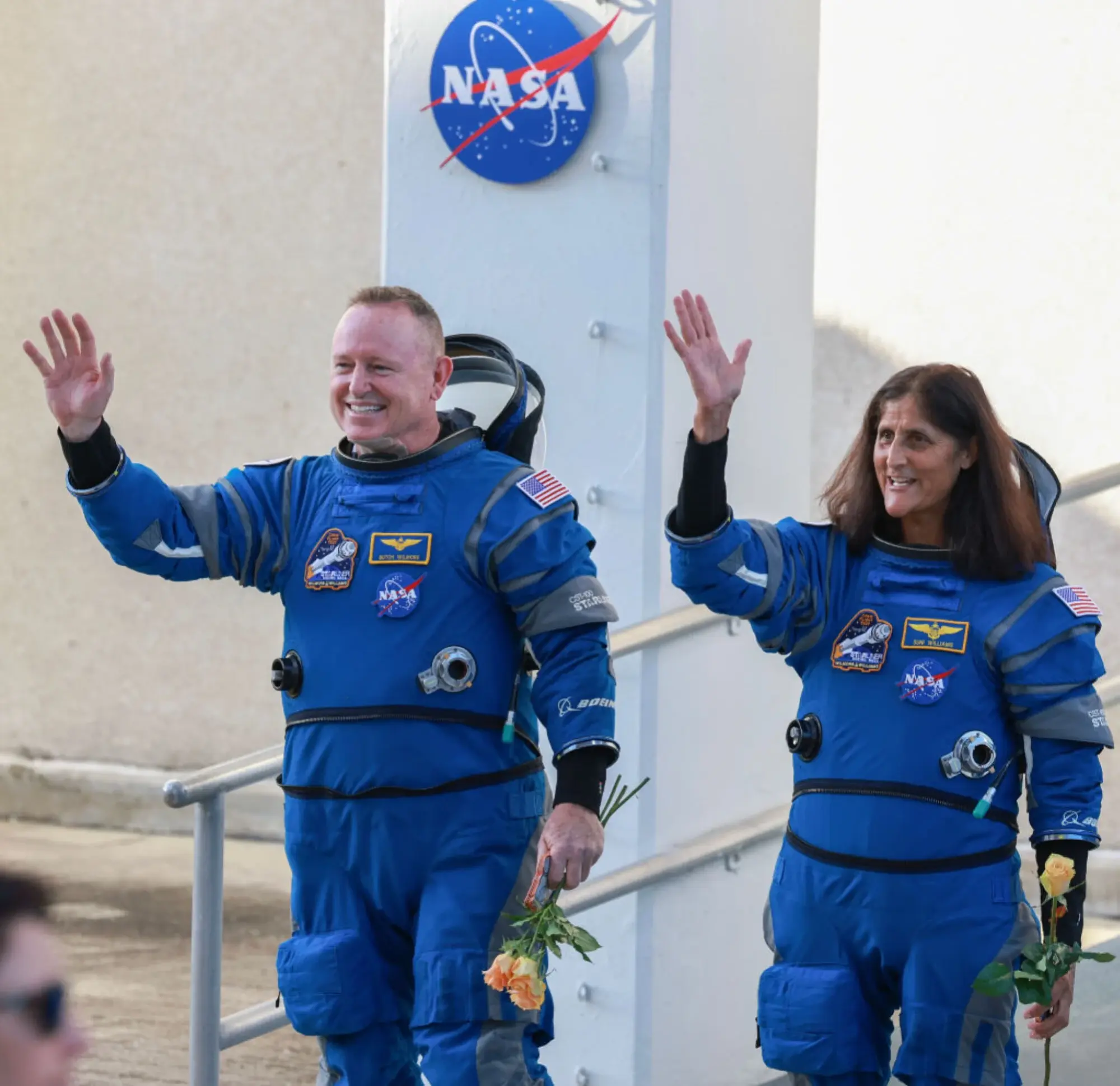 NASA astronauts Butch Wilmore and Suni Williams waving before launch