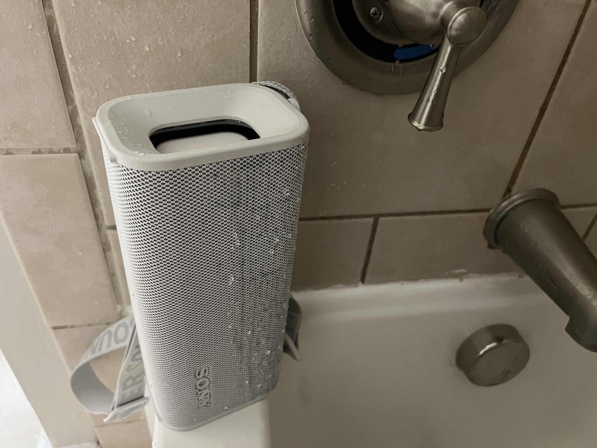 sony speaker in a shower covered in water droplets