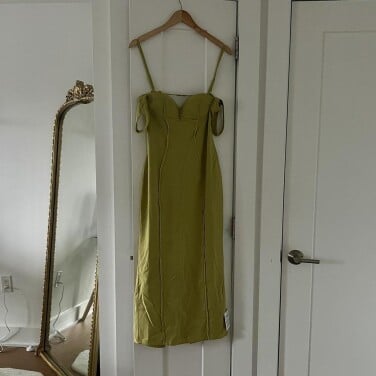 Green dress hanging on closet door
