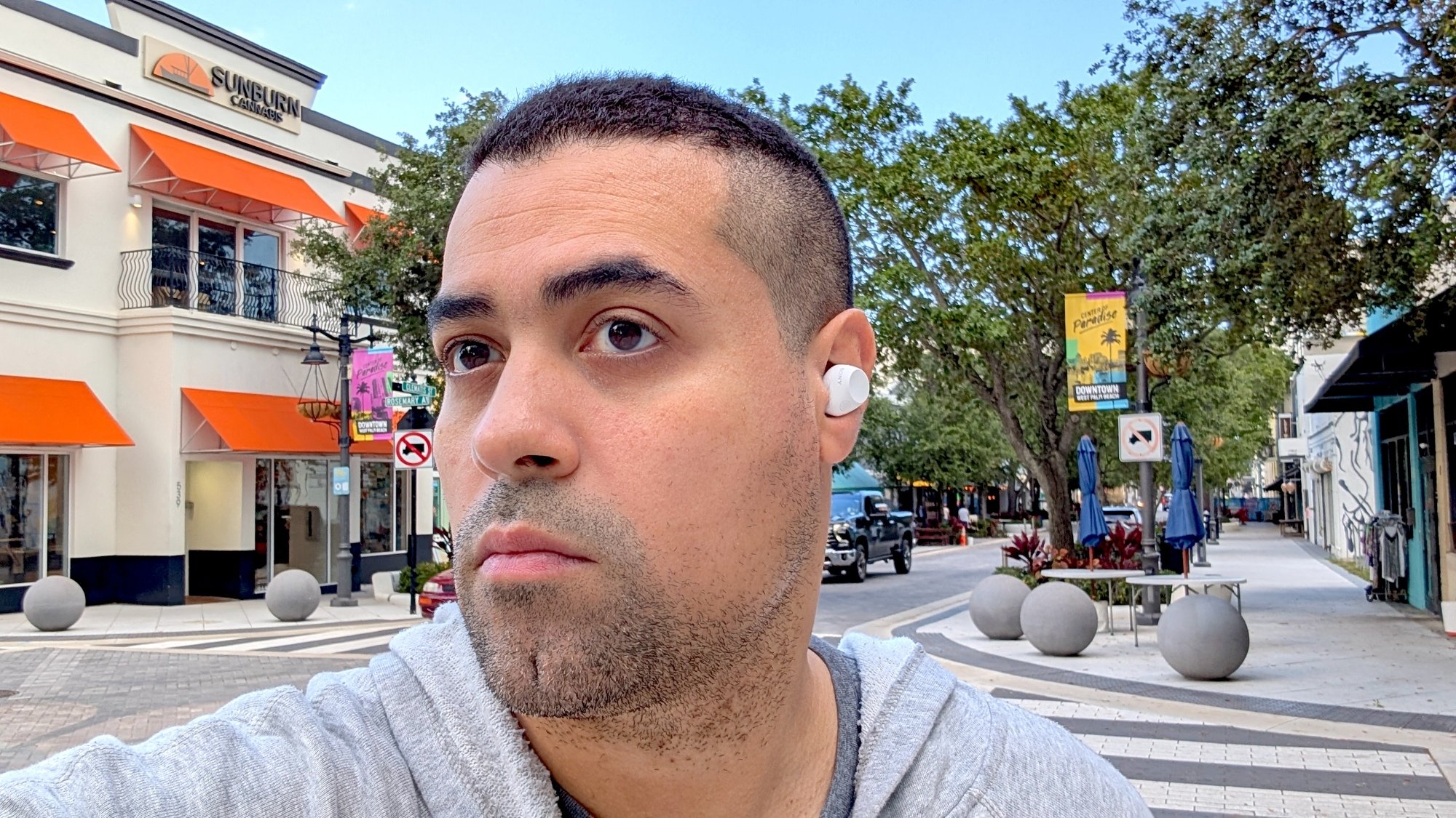 the author wearing the sony earbuds outside